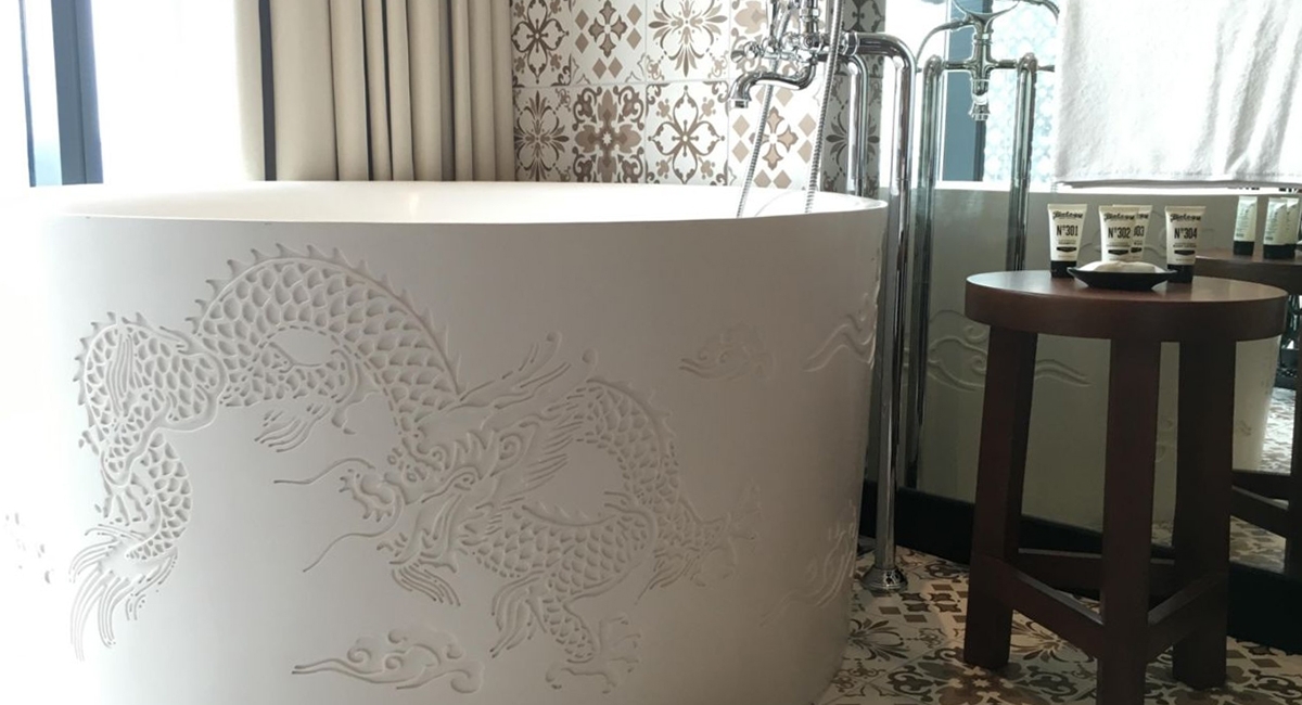 Hotel Indigo Katong bath's features an intricate dragon motif inlay that symbolize power, strength and good luck into the bath design.