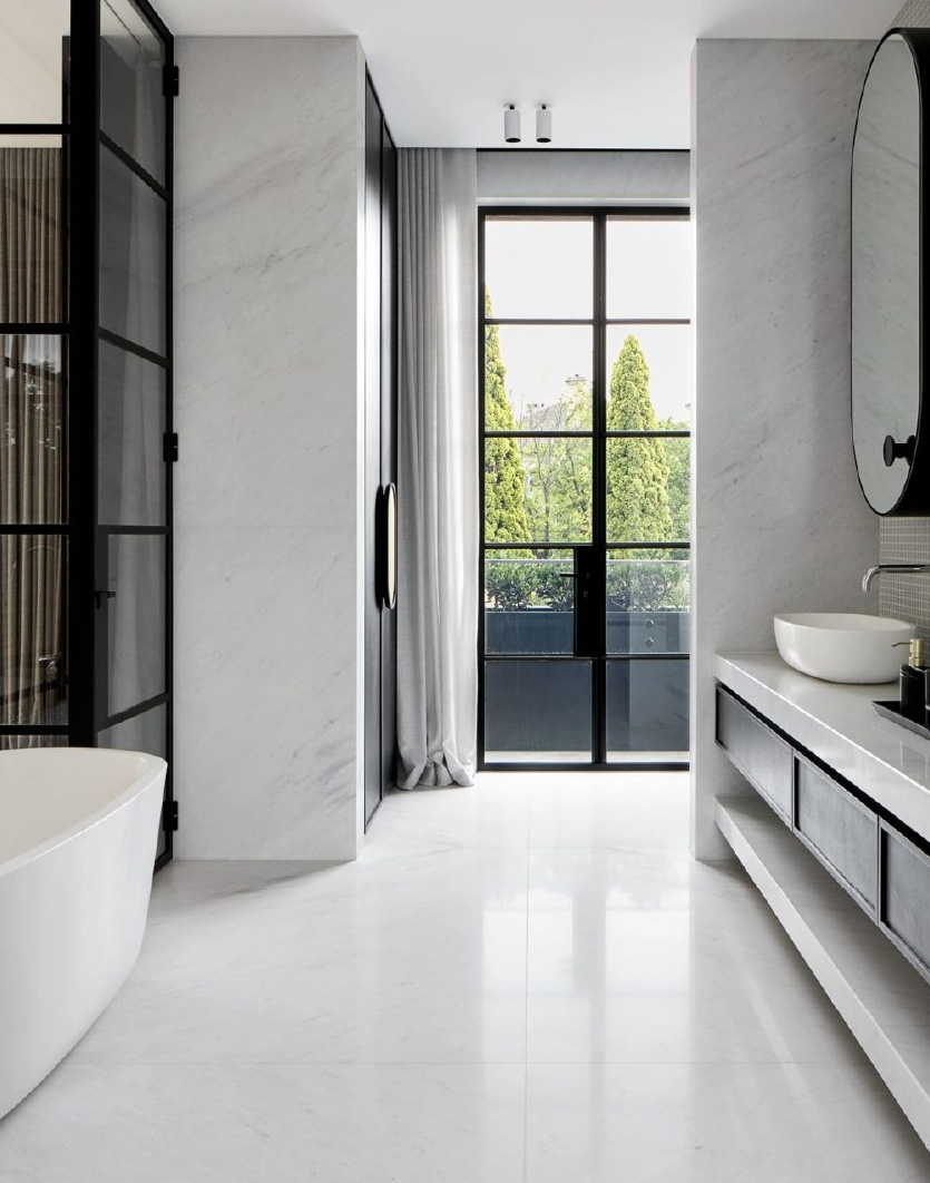 apaiser freestanding bath in a large designer bathroom with a white and black colour scheme